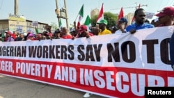 FILE - Nigerians protest against high cost of living and massive suffering following a hike in fuel prices and devaluation of the naira, in Abuja, Nigeria, Feb. 27, 2024. The government has taken some steps to alleviate the situation, but more protests are planned for August.