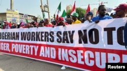 FILE - Nigerians protest against high cost of living and massive suffering following an increase in fuel prices in Abuja, Nigeria, Feb. 27, 2024.