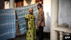 Maurice, 35-year-old, and Esperanze, 26-year-old, both Ebola survivors are seen outside their home in Beni , north eastern Democratic Republic of the Congo on September 17, 2019.