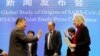 Marion Koopmans, right, and Peter Ben Embarek, center, of the World Health Organization team say farewell to their Chinese counterpart Liang Wannian, left, after a WHO-China Joint Study Press Conference held at the end of the WHO mission in Wuhan, China, 
