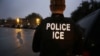 FILE - U.S. Immigration and Customs Enforcement (ICE) agents search for a suspect during an early morning operation in Dallas, Texas, March 6, 2015.