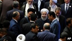 Iran's President Hasan Rouhani, center, leaves the parliament at the end of his swearing-in ceremony for the second term in office, in Tehran, Iran, Saturday, Aug. 5, 2017.