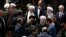 Iran's President Hasan Rouhani, center, leaves the parliament at the end of his swearing-in ceremony for the second term in office, in Tehran, Iran, Saturday, Aug. 5, 2017.