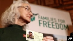 Debra Tice, the mother of American journalist Austin Tice, who went missing in Syria in 2012, holds a card with a photo of her son during a press conference in Damascus, Syria, Jan. 20, 2025. 