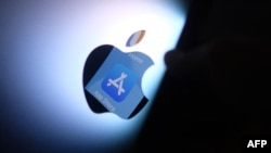 (FILES) This illustration photo shows the Apple app store logo reflected from an iPhone onto the back of an iMac in Los Angeles, August 26, 2021.