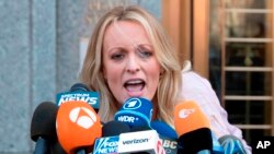 FILE - Adult film actress Stormy Daniels addresses reporters outside federal court in New York,April 16, 2018.