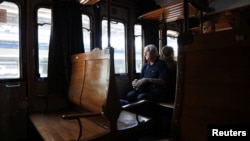 A passenger travels on board of a vintage train that departed from Sulmona on the way to Palena, Italy July 21, 2024. (REUTERS/Antonio Denti)