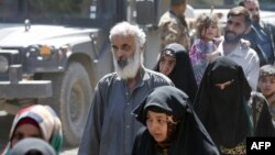 FILE - Iraqis flee west Mosul, June 3, 2017, during the ongoing offensive by security forces to retake the city from Islamic State fighters.