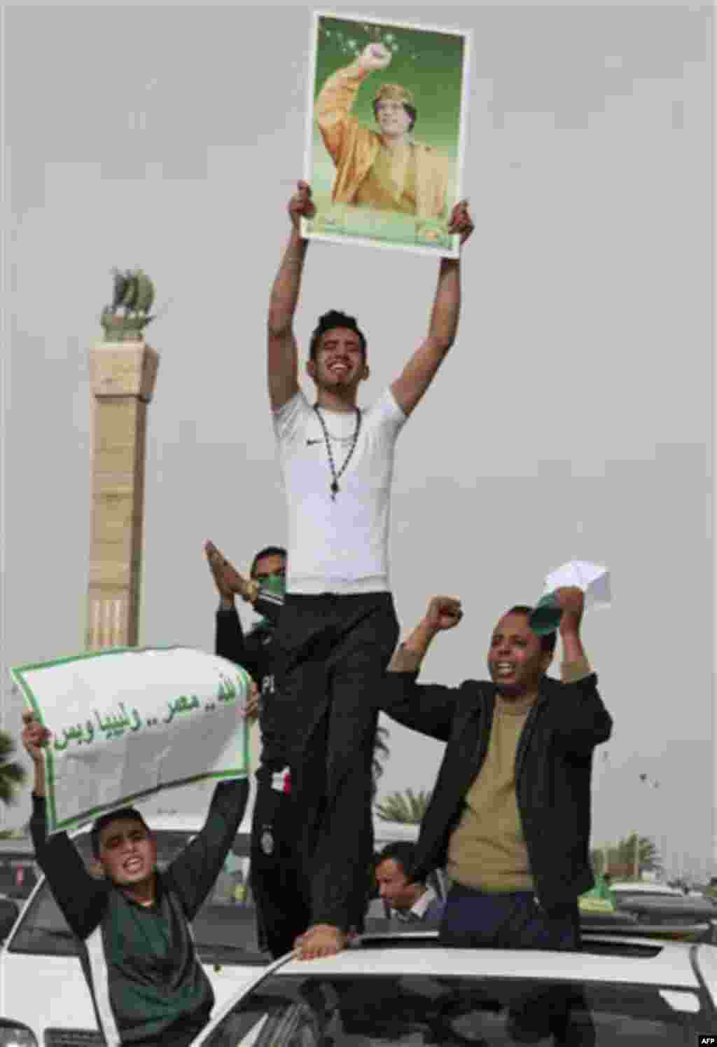 Pro-Gadhafi supporters gather in Green Square after traditional Friday prayers in Tripoli, Libya, Friday, Feb. 18, 2011. Protesters battled with security forces for control of neighborhoods Friday in the eastern city of Beyida where dozens have reportedly