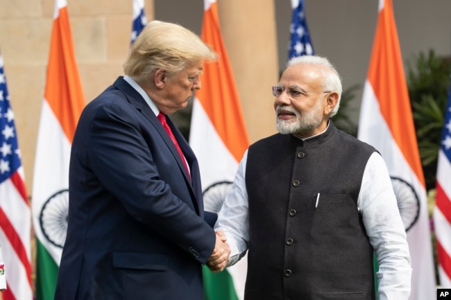 FILE - Former U.S. President Donald Trump, left, and Indian Prime Minister Narendra Modi shake hands before meeting in New Delhi, India, Feb. 25, 2020. Some Republican activists are betting Trump's close ties to Modi will translate into votes for Trump in November.