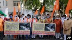 Supporters of Vishwa Hindu Parishad, or World Hindu Council, hold posters showing coffins of Indian army soldiers killed in clashes with China, during a protest in Ahmedabad, India, Saturday, June 20, 2020. China said the Galwan Valley high up in…