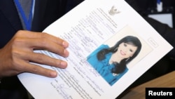 Thai Raksa Chart party leader Preechapol Pongpanich, holds up application of candidate for Prime Minister, Thailand's Princess Ubolratana Rajakanya Sirivadhana Barnavadi, at the election commission office in Bangkok, Thailand, Feb. 8, 2019. 