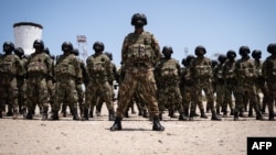 FILE - Mozambican soldiers stand as Mozambican President Filipe Nyusi and Rwanda President Paul Kagame review the troops on Sept. 24, 2021, in Pemba, Cabo Delgado province, Mozambique.