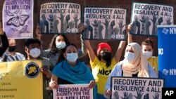 FILE - Demonstrators with the New York Immigration Coalition rally asking President-elect Joe Biden to prioritize immigration reform, Nov. 9, 2020, in New York. 