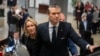 Pete Hegseth, President-elect Donald Trump's nominee to be defense secretary, is joined by his wife, Jennifer Rauchet, as they take an escalator in the Capitol, Dec. 4, 2024, in Washington.