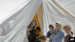 Syrian refugees are seen in a camp, in Boynuyogun, Turkey, Tuesday, June 14, 2011.