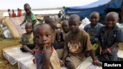 FILE - Burundian refugee children pose for a photograph at the Lake Tanganyika stadium in Kigoma, Tanzania, May 19, 2015. 