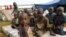 FILE - Burundian refugee children pose for a photograph at the Lake Tanganyika stadium in Kigoma, Tanzania, May 19, 2015. 