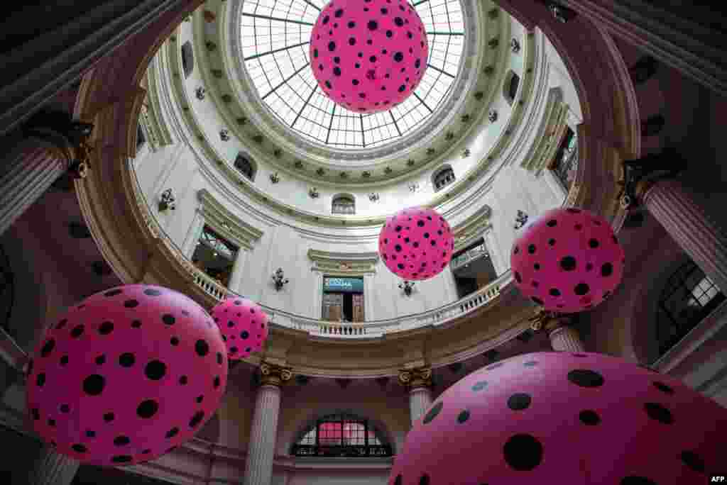 People look at an installation of the exhibition "Infinite Obsession" by 84-year-old Japanese female artist Yayoi Kusama at the Banco do Brasil Cultural center in Rio de Janeiro, Brazil.