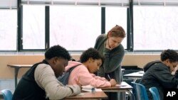 Crosby High School algebra teacher Jennifer Desiderio works with freshman students in her class in Waterbury, Conn., Nov. 7, 2019. 
