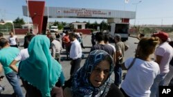 FILE - Relatives and friends of prisoners wait outside a high security prison complex in Silivri, about 80 kilometers (50 miles) west of Istanbul, Aug. 18, 2016. 