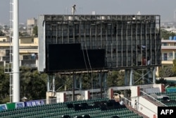 Workers install a screen at the Rawalpindi Cricket Stadium ahead of the International Cricket Council Champions Trophy matches in Rawalpindi, Pakistan, on Feb. 17, 2025.