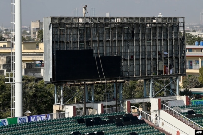 Workers install a screen at the Rawalpindi Cricket Stadium ahead of the International Cricket Council Champions Trophy matches in Rawalpindi, Pakistan, on Feb. 17, 2025.