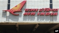 Pedestrians walk past India's flagship carrier Air India's headquarters in Mumbai on May 6, 2011.