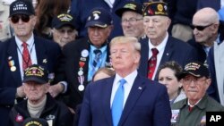 U.S. President Donald Trump stands with World War II veterans during a ceremony to mark the 75th anniversary of D-Day at the Normandy American Cemetery in Colleville-sur-Mer, Normandy, France, June 6, 2019.