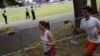 Runners pass by the Hatch Memorial Shell in Boston, Massachusetts, July 3, 2014.