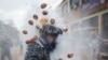 Revellers dressed in mock military garb take part in "Els Enfarinats" flour-battle in the southeastern Spanish town of Ibi, Dec. 28, 2024.