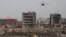 A drone operated by paramilitary police flies over the site of last week's explosions at Binhai new district in Tianjin, China, August 17, 2015.