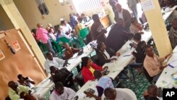 Workers inside a call center, where people can phone to state their concerns about the Ebola virus, in the city of Monrovia, Liberia, Saturday, Aug. 9, 2014.