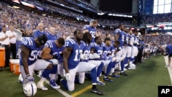 Players of the Indianapolis Colts kneel during the nation anthem before an NFL football game against the Cleveland Browns in Indianapolis, Indiana, Sept. 24, 2017.
