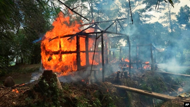 FILE - In this Sept. 7, 2017, photo, houses are on fire in Gawdu Zara village, northern Rakhine state, Myanmar.