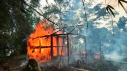 FILE - In this Sept. 7, 2017, photo, houses are on fire in Gawdu Zara village, northern Rakhine state, Myanmar.