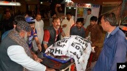 Volunteers carry the body of a shooting attack victim, at a hospital in Quetta, Pakistan, April 2, 2018.