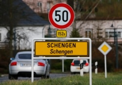 FILE - A street sign marks the beginning of Schengen zone, Luxembourg, Jan. 27, 2016.