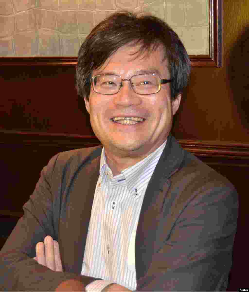 Physicist Nobel co-winner Hiroshi Amano, a professor at Nagoya University, smiles as he answers a question in Grenoble, France, Oct. 7, 2014. 