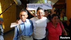 Teodora Vasquez, who in 2008 had been sentenced to 30 years in jail on charges of aggravated murder after inducing an abortion, walks out of jail accompanied by her parents after El Salvador's Supreme Court commuted her sentence, in Ilopango, El Salvador, Feb. 15, 2018.