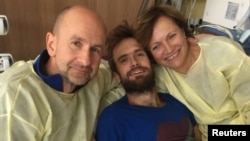 Pyotr Verzilov's parents visit him at Charite Hospital in Berlin, Germany, in this handout photo obtained Sept. 22, 2018. Cinema for Peace Foundation/Handout via Reuters. 