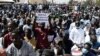 FILE - A man holds a sign reading 'My son will not be an homosexual' during a protest called by religious associations against homosexuality on May 23, 2021, on the Obelisque square in Dakar, Senegal. 