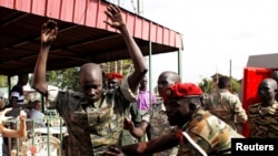 A South Sudanese soldier is checked as he arrives for a sentencing over the rape of foreign aid workers and the murder of a local journalist in an assault on the Terrain Hotel in the capital Juba in 2016 at a military court in Juba, South Sudan, Sept. 6, 2018.