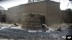 FILE: In this photo taken on Friday, Jan. 31, 2014, a burned house is pictured following an attack by gunmen, in Wada Chakawa, Yola, Nigeria.