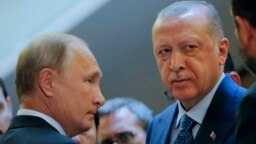 Russian President Vladimir Putin (L) and Turkish President Recep Tayyip Erdogan prepare to enter a hall for their talks at the Bocharov Ruchei residence, in Sochi, Russia, Sept. 17, 2018.