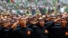 Members of Banser, the security unit of Indonesia's largest Muslim organization, Nahdlatul Ulama (NU), salute guests during a parade to commemorate the organization's 85th anniversary in Gelora Bung Karno Stadium in Jakarta, July 17, 2011. 