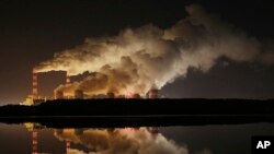 FILE - Plumes of smoke rise from Europe's largest lignite power plant in Belchatow, central Poland, Nov. 28, 2018.