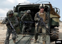 FILE - U.S. and South Korean Marines run from a South Korean assault amphibious vehicle during joint military exercises in Pohang, south of Seoul, April 26, 2013.