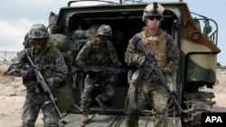 FILE - U.S. and South Korean Marines run from a South Korean assault amphibious vehicle during joint military exercises in Pohang, south of Seoul, April 26, 2013.