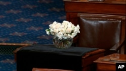 The desk of Sen. John McCain, R-Ariz., is draped in black on the floor of the U.S. Senate, Aug. 27, 2018, on Capitol Hill in Washington.